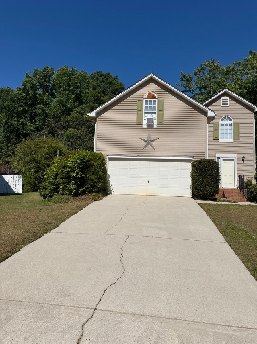 Driveway and home exterior cleaned by Apex Exterior Services